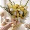 Sunlit yellow roses and tall snapdragon spikes make a cheerful first impression