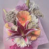 Assorted flowers which may vary, presented in a designer embossed floral wrap