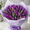 An elegant arrangement of premium purple tulips wrapped in luxurious lilac paper