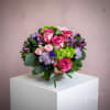 This exclusive bouquet features a gathering of blooms in bright, cheerful colors