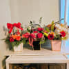 A cheerful cluster of compact floral baskets perfect for an everyday gift