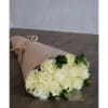 Bouquet of cream-colored roses wrapped in tan paper