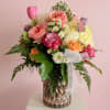 Pink roses and soft pastels take center stage in this rounded, full