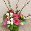 Pink and white roses in a green vase with pussy willow branches
