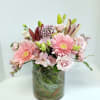 Pink and white mixed flower bouquet in a glass vase