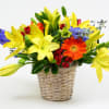 Yellow lilies and mixed flowers in a woven basket