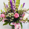 Pink and white mixed flower arrangement in a glass vase