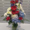 A tall, layered mixed flower arrangement made for celebration and everyday display