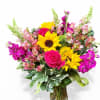 An upright bright and cheerful arrangement the perfect addition to any celebration.