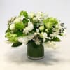 White floral arrangement in a green glass vase