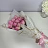 Delicate blush roses beautifully wrapped in elegant white and gold paper, thoughtfully
