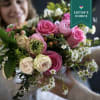 Bouquet of pink and cream roses with small white filler flowers