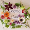 Assorted flowers arranged around the words 