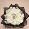 Round bouquet of ivory roses with baby's breath and silver butterflies in black wrap