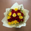 A radiant mix of red and yellow roses gives this flower arrangement