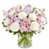 Pink and white bouquet of roses, alstroemeria, and carnations in a glass vase