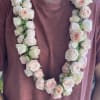 A Lei made of lush spray roses.