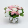 This delicate arrangement features a lovely mix of soft pink and white