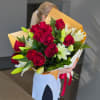 A beautiful bouquet of vibrant dozen red roses and fresh white lilies