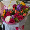 A lively and colorful bouquet bursting with energy, featuring bold fuchsia roses