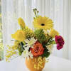 A bright, cheerful, and uniquely creative floral arrangement styled directly inside a