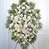 An elegant all-white standing spray designed to honor with grace and timeless