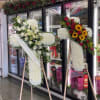 Two large floral standing sprays on easels with white and red flowers