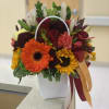 Mixed bouquet with sunflowers, roses, and a white handled container