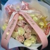 Pink and cream rose bouquet with birthday ribbons and a gold crown topper