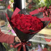 Bouquet of red roses wrapped in black and red paper