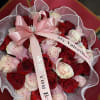 Bouquet of red and pale pink roses with a pink ribbon