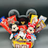 Mickey and Minnie plush toys in a black gift box with assorted candy