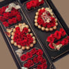 Bold red roses arranged in sleek black gift boxes create a dramatic