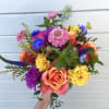 Colorful bouquet with roses, dahlias, and blue accent flowers