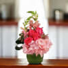 Bright pink roses paired with pale pink hydrangeas create a joyful, feminine