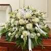 A premium all-white casket spray designed with timeless beauty and grace. This
