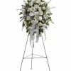 A timeless and elegant all-white standing spray, beautifully arranged to express peace