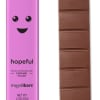 Pink chocolate bar wrapper beside a segmented milk chocolate bar