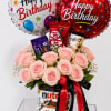 A dense cluster of pale pink roses set beneath two large birthday