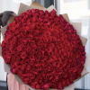 Large bouquet of red roses wrapped in brown paper