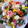 Mixed bouquet of roses, tulips, calla lilies, and anthurium in white wrap