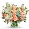 Large white lilies open like soft stars above peach roses and coral-tinged