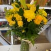 Yellow bouquet of roses and chrysanthemums in a glass vase