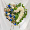 Heart-shaped floral wreath of roses on an easel