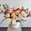 A soft, elegant garden-style arrangement designed with a refined, airy feel. Featuring