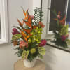 A large beautiful display of tropical flowers in a basket  of