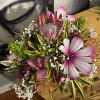 A  mixed tropical centerpiece arrangement, low in compact in a lovely