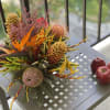 Seasonal tropical arrangement includes seasonal decor and holiday trinkets something fun to