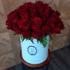 Bouquet of red roses in a white hat box