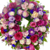 Heart-shaped bouquet of pink, purple, and cream roses